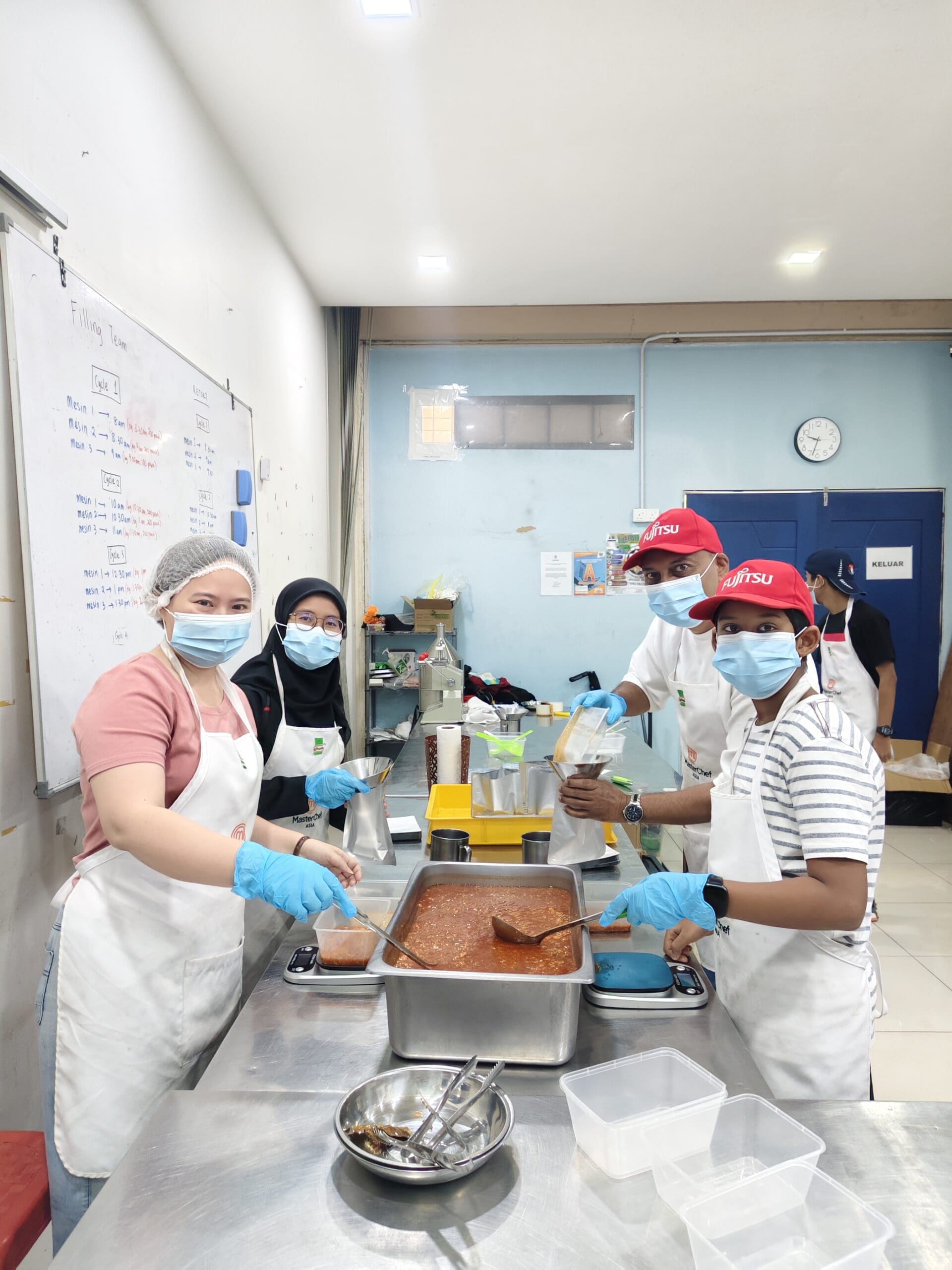 People using face masks while preparing food